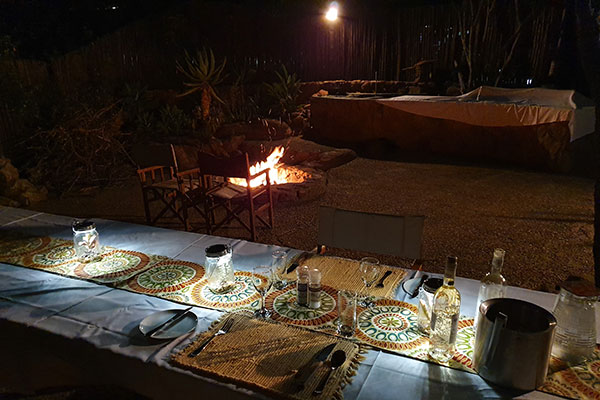 Lantern lit outdoor dining at Sekala Private Game Lodge