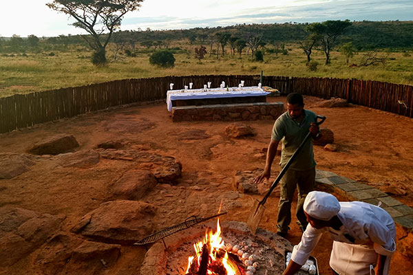 Open-fire cooking during bush dining experience