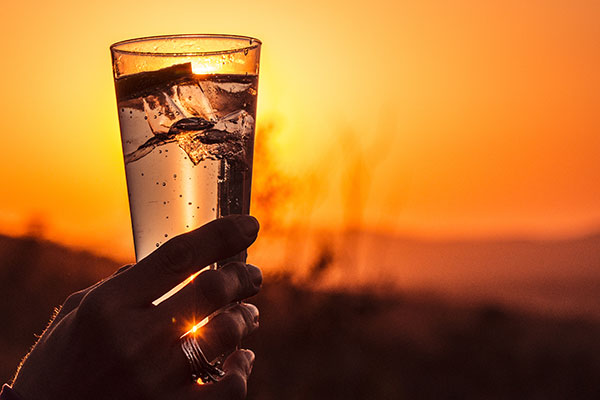 Sundowner drinks with African sunset view